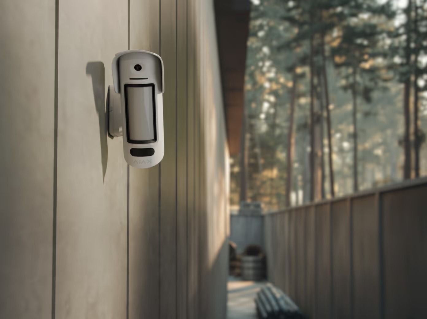 White Security Camera on a Wooden Wall, Overlooking a Narrow Passage With Trees — Cussler NQ in Bowen, QLD