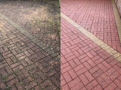 Brick pavement split into worn dark and red sections by a pale diagonal stripe.