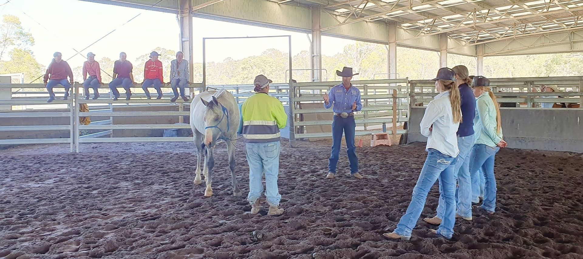 A Group Of People Standing In A Horse Ring — Jono Battle Equine Services In Charters Towers, QLD