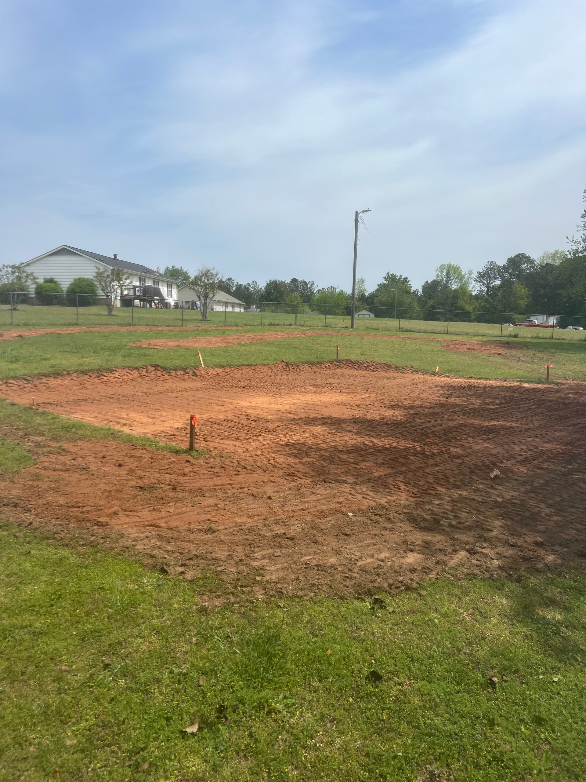 A baseball field with a lot of dirt and grass.
