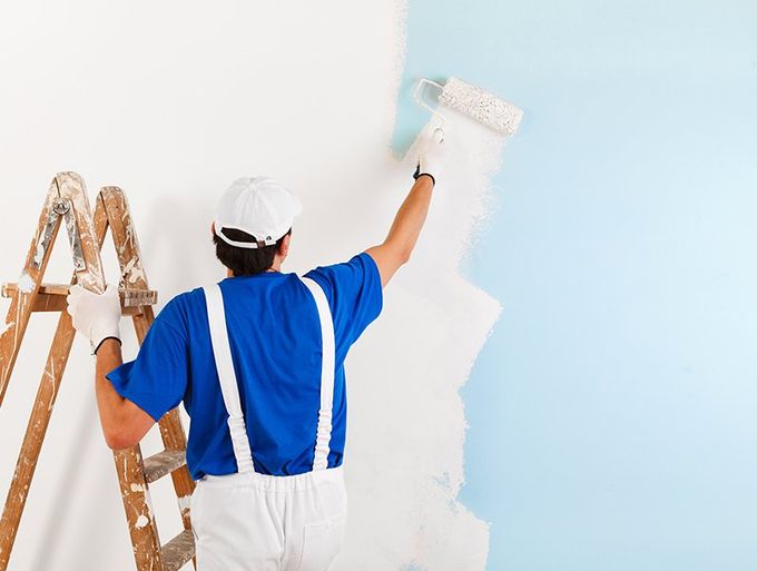 Worker Painting White Wall
