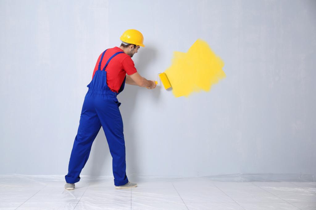 Worker In Uniform With Yellow Paint