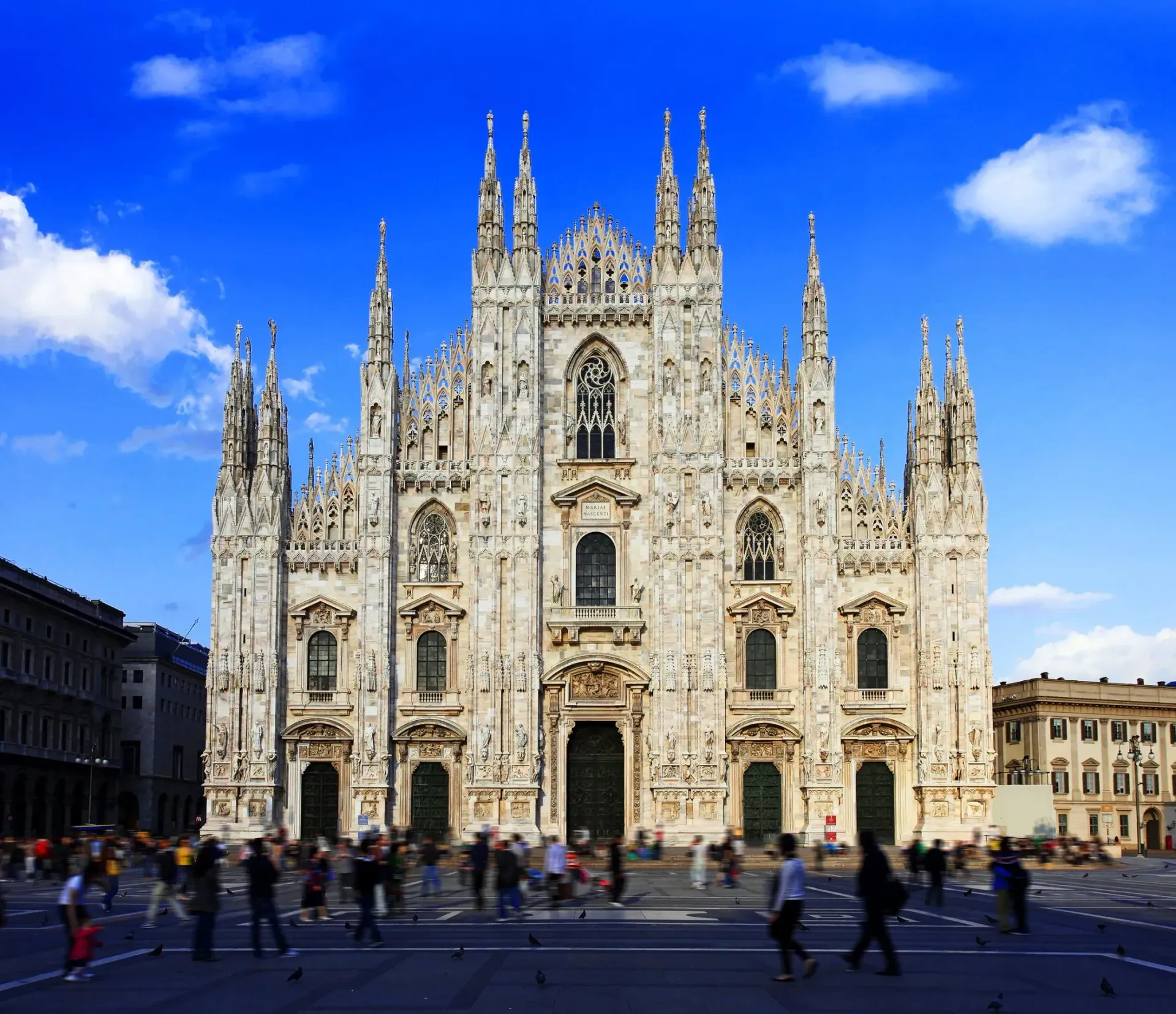 A large white building with a blue sky in the background