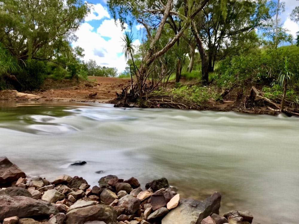 Flowing River Amidst Smooth Stones — Southern Blinds & Awnings In Wilton NSW