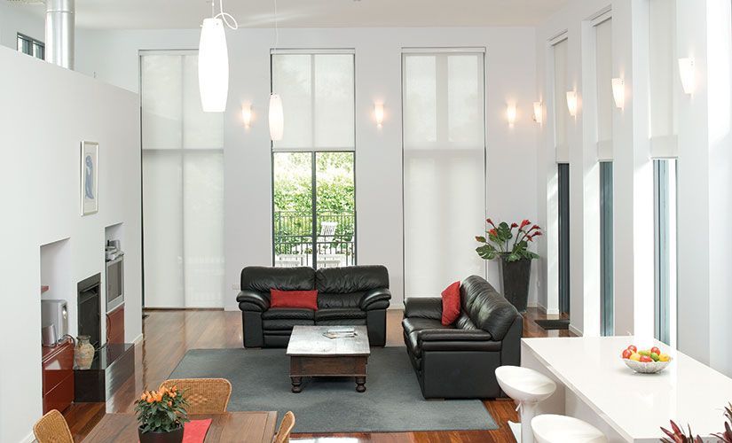 Living Room Enhanced by Stylish Roller Blinds and Black Sofa — Southern Blinds & Awnings In Balaclava NSW