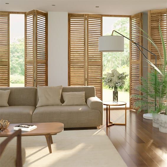 An Open Wooden Shutters  In The Living Room With A Couch And A Table — Southern Blinds & Awnings In Balaclava NSW