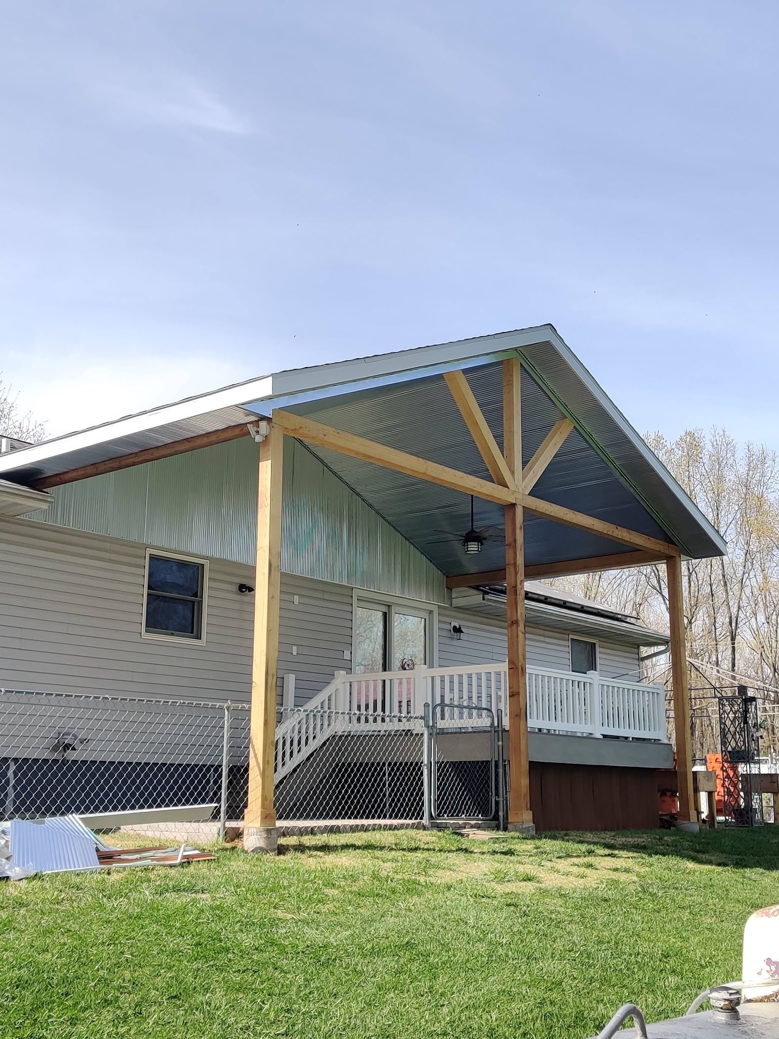 A house with a metal roof and a wooden porch.