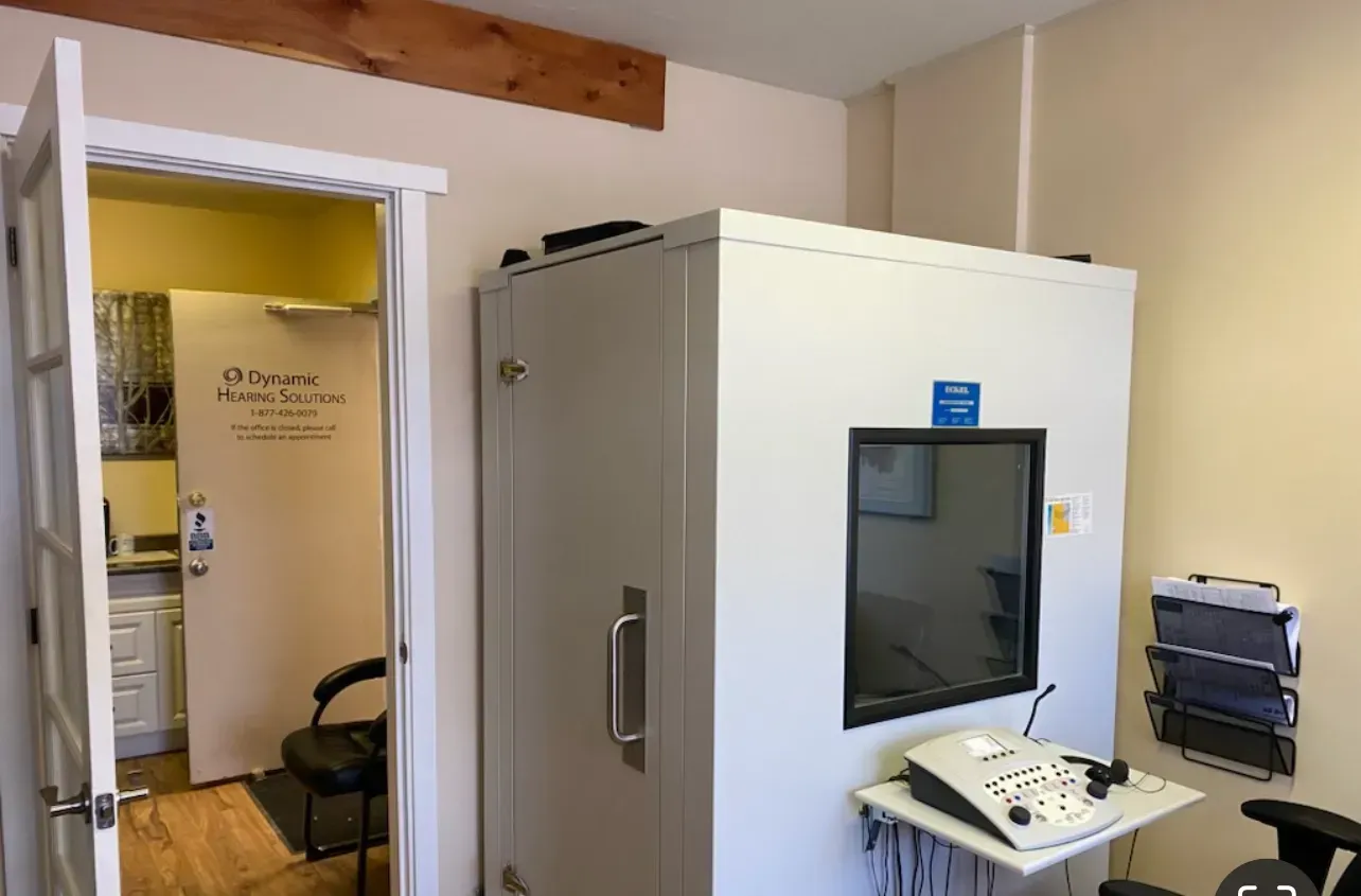 A soundproof booth in a medical office, next to an open doorway.