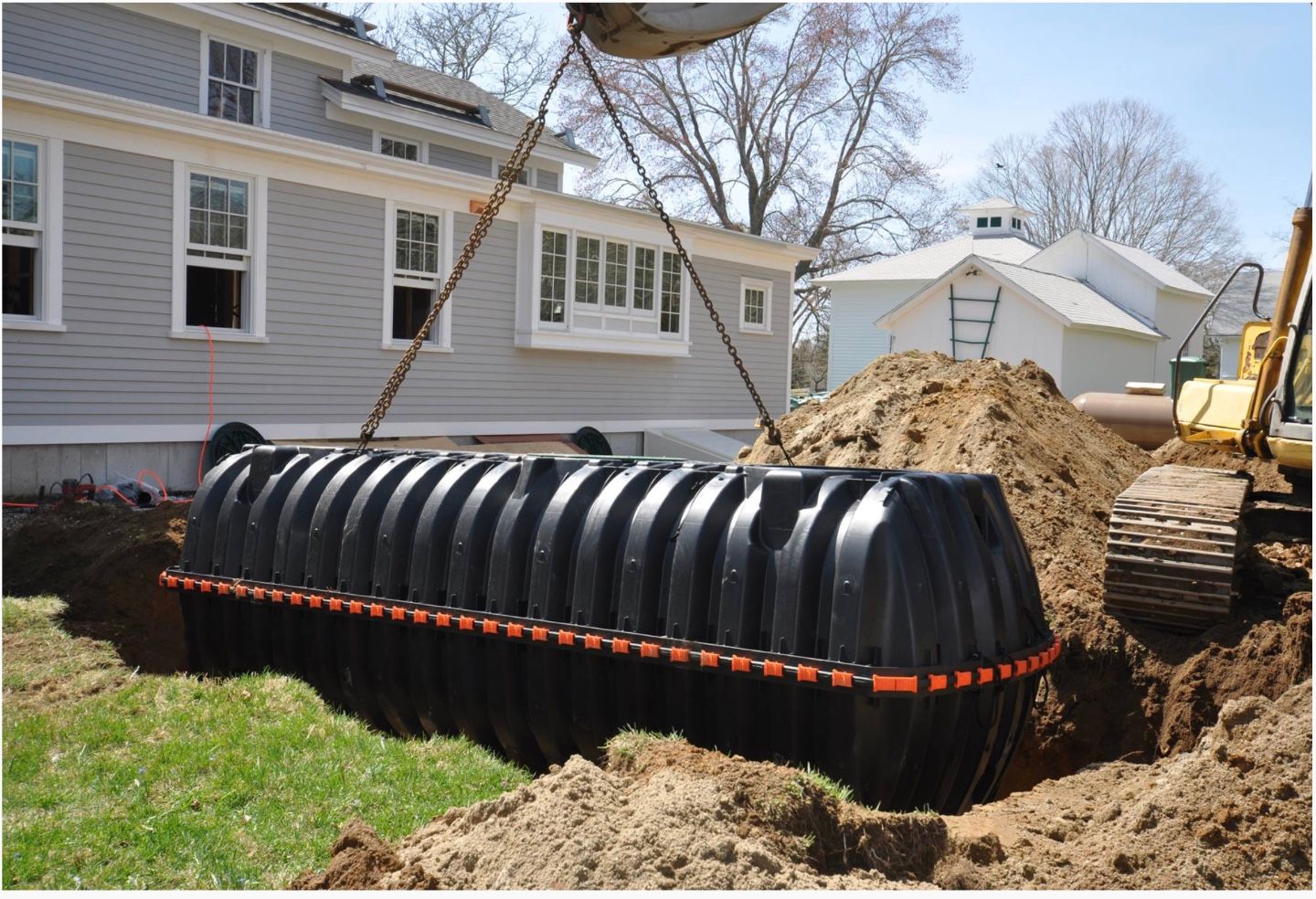 A plastic Septic tank being lowered into  place.