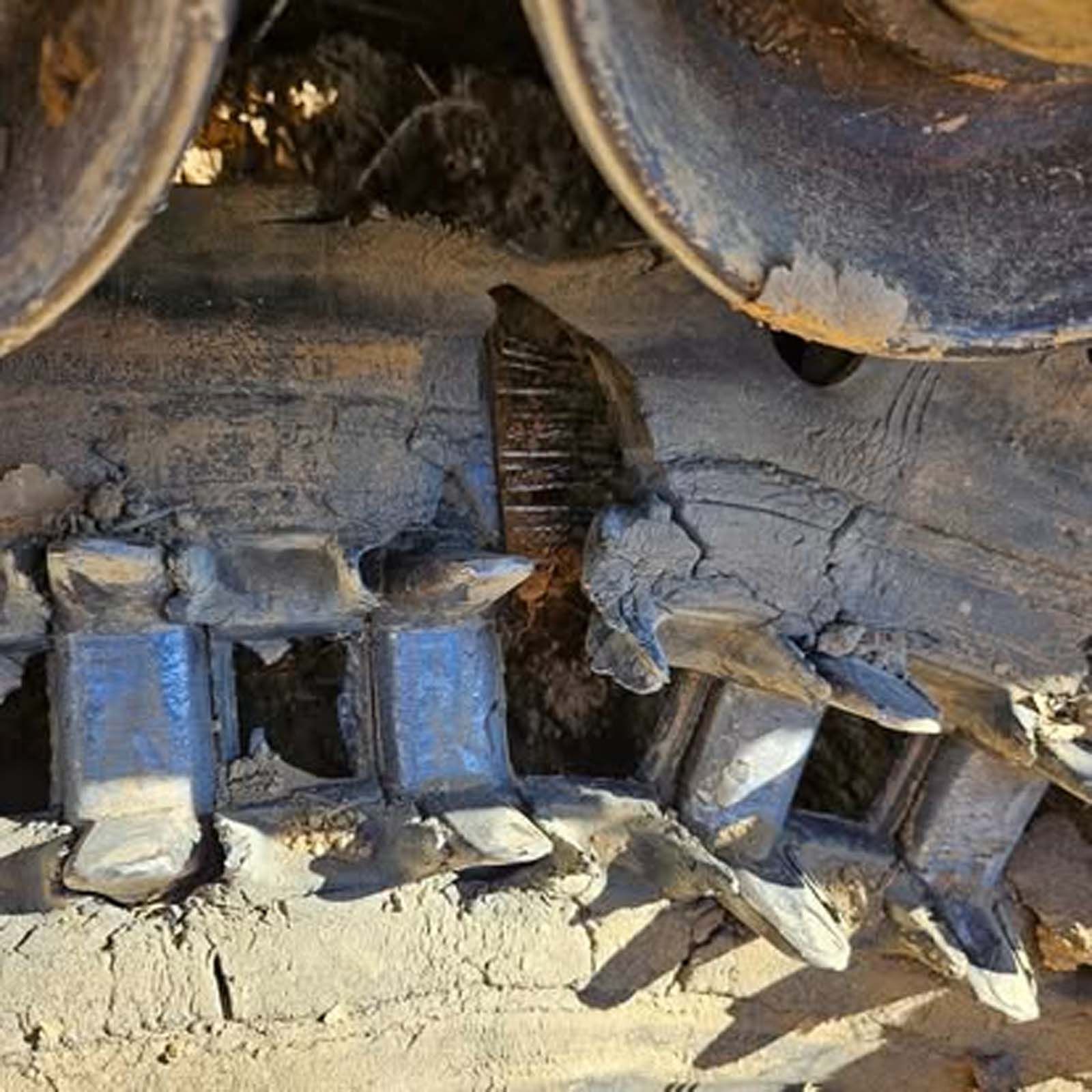 A close up of the tracks of a bulldozer.