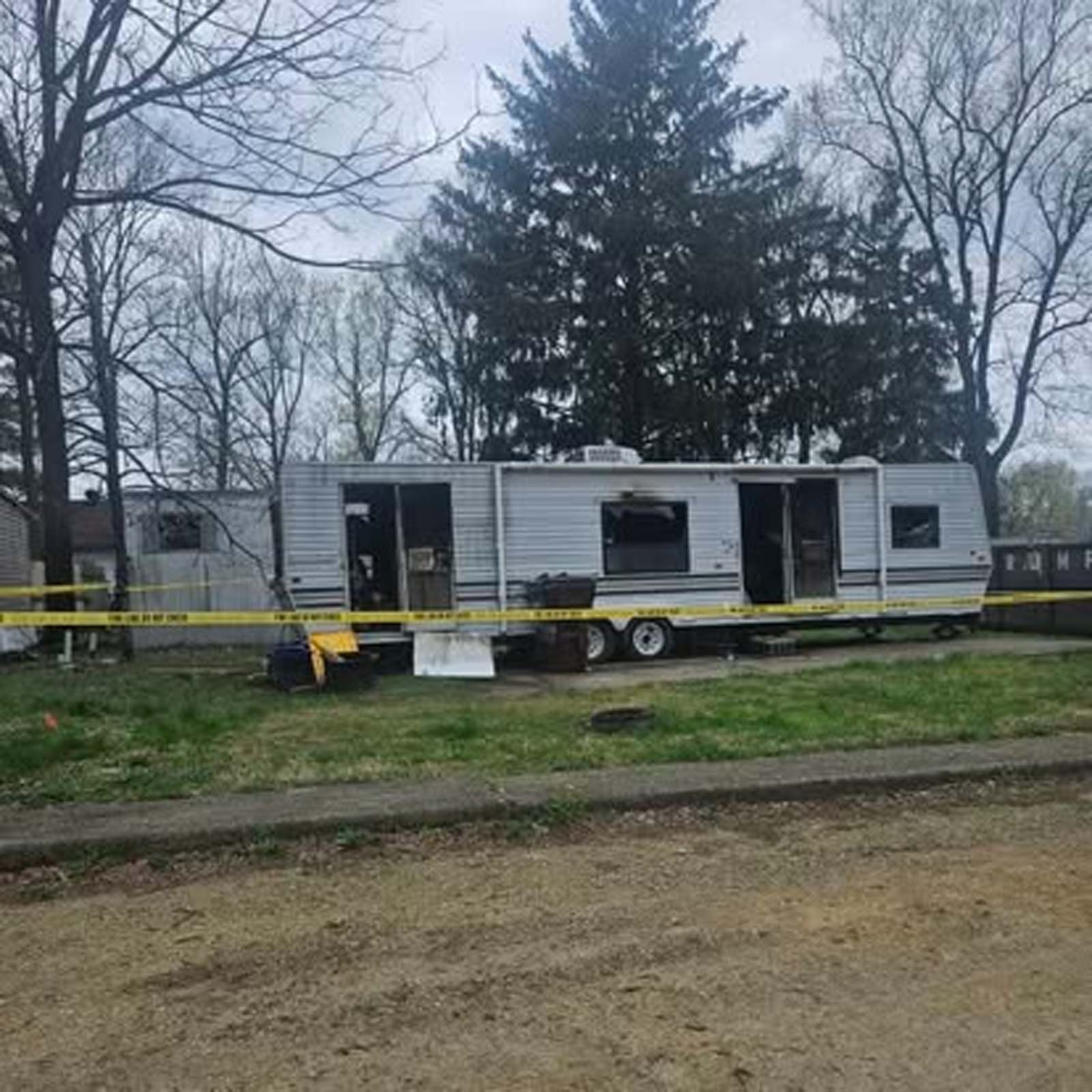 A trailer is parked in front of a house.