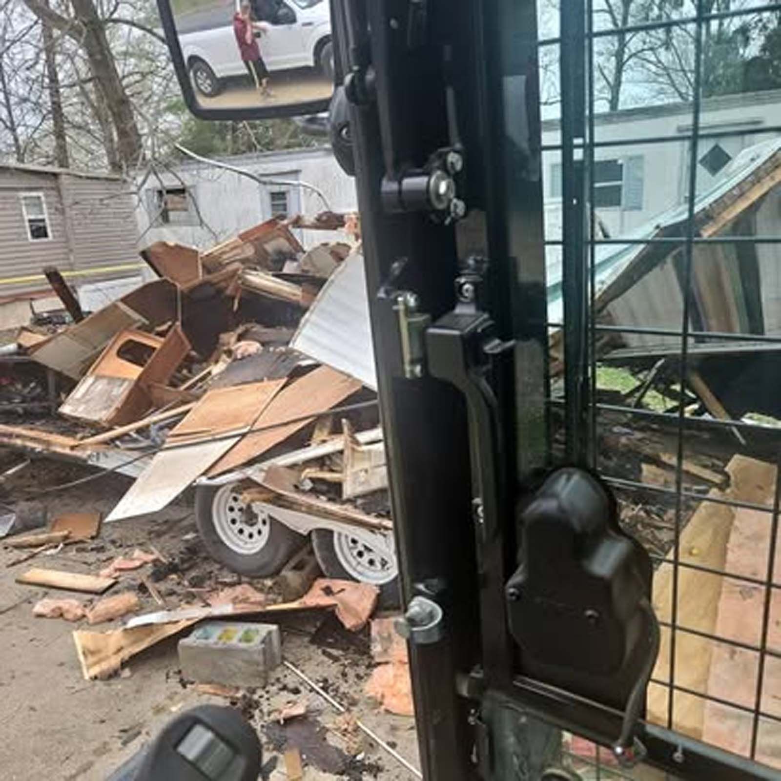 A bulldozer is sitting in front of a pile of rubble.