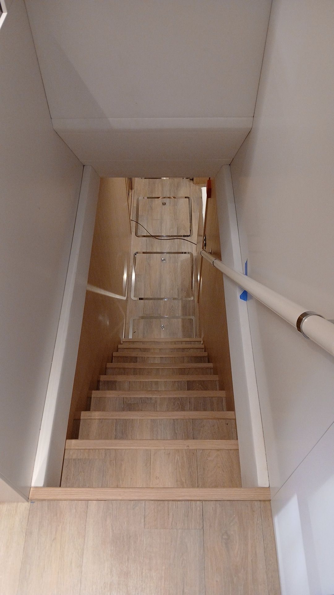 Una serie di scale che portano a un seminterrato con una ringhiera.