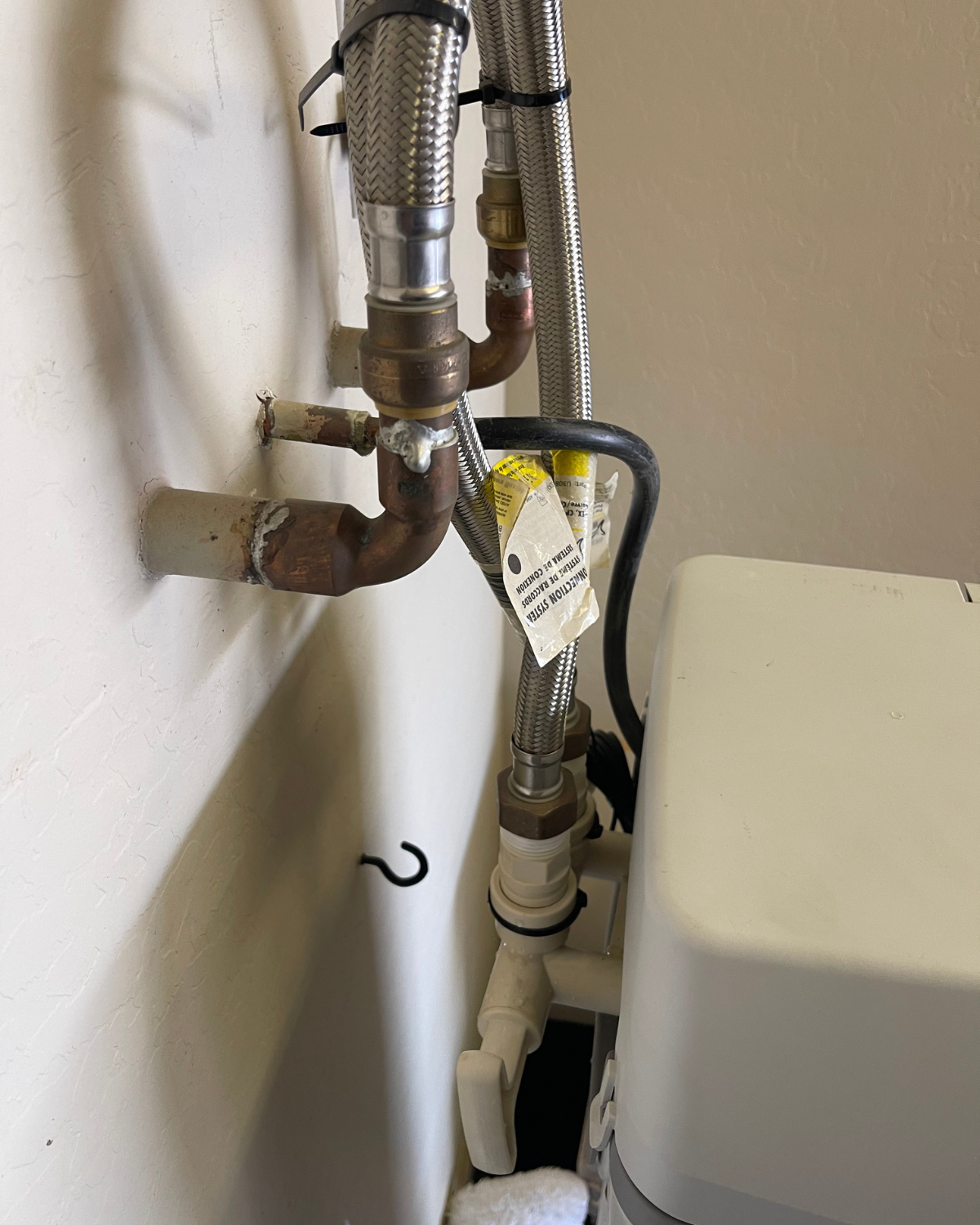 A close up of a pipe with a yellow tag on it