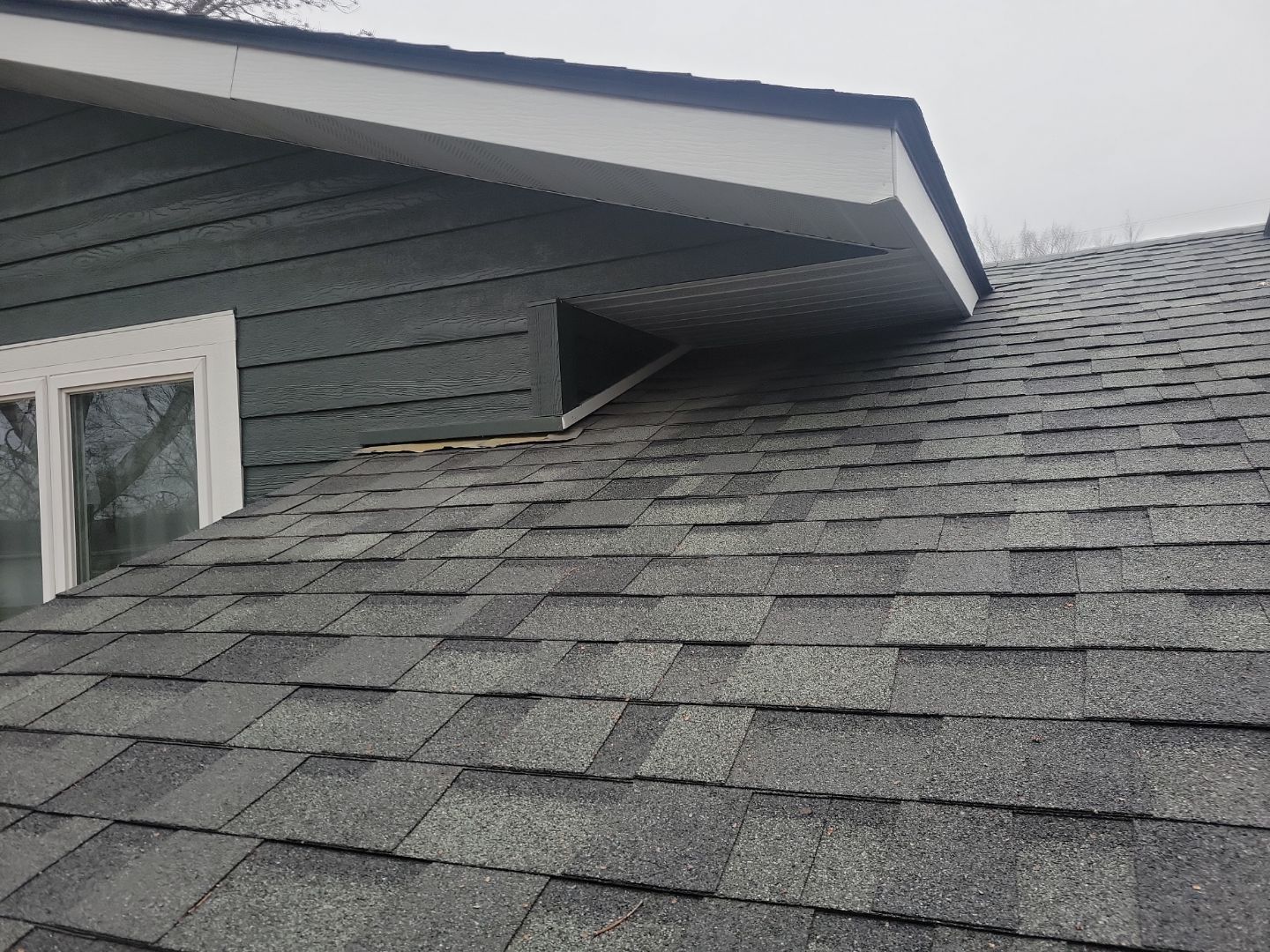 a house with a ladder on the side of it is being painted .