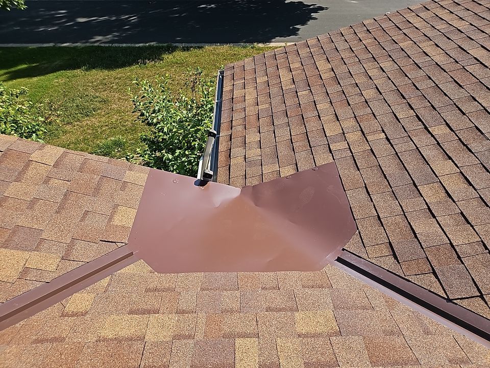 the back of a house with a screened in porch and a deck .