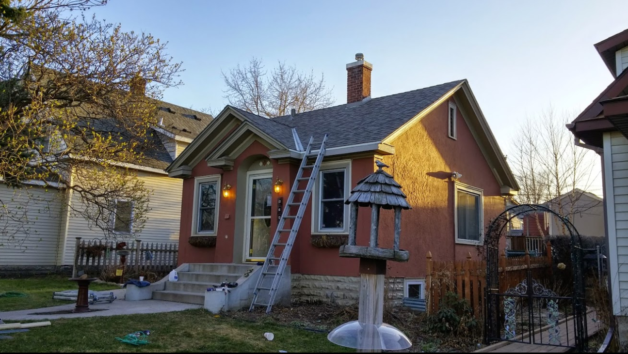 a house with a truck parked in front of it .