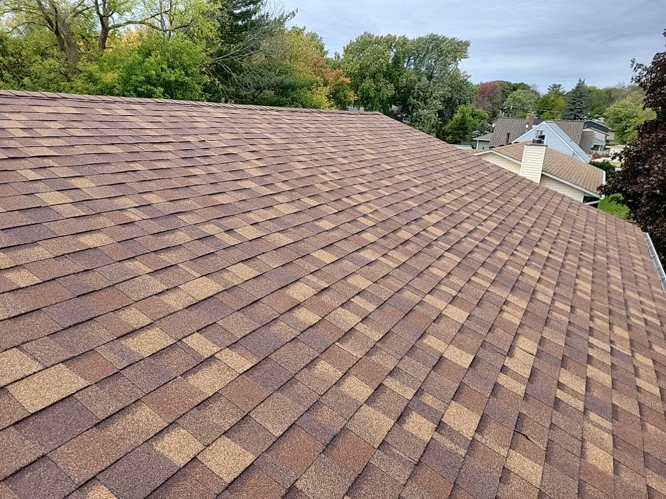 a white vinyl fence is sitting in front of a house .