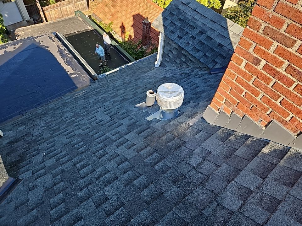 a close up of a roof with shingles on it .
