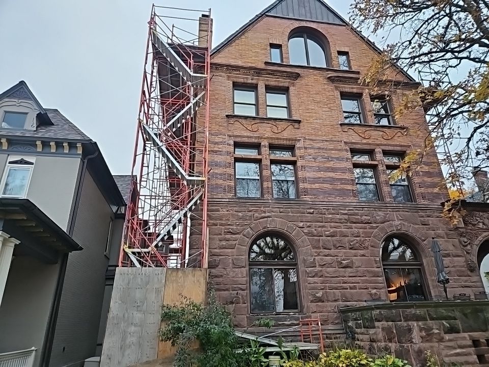a large brick building with scaffolding on the side of it
