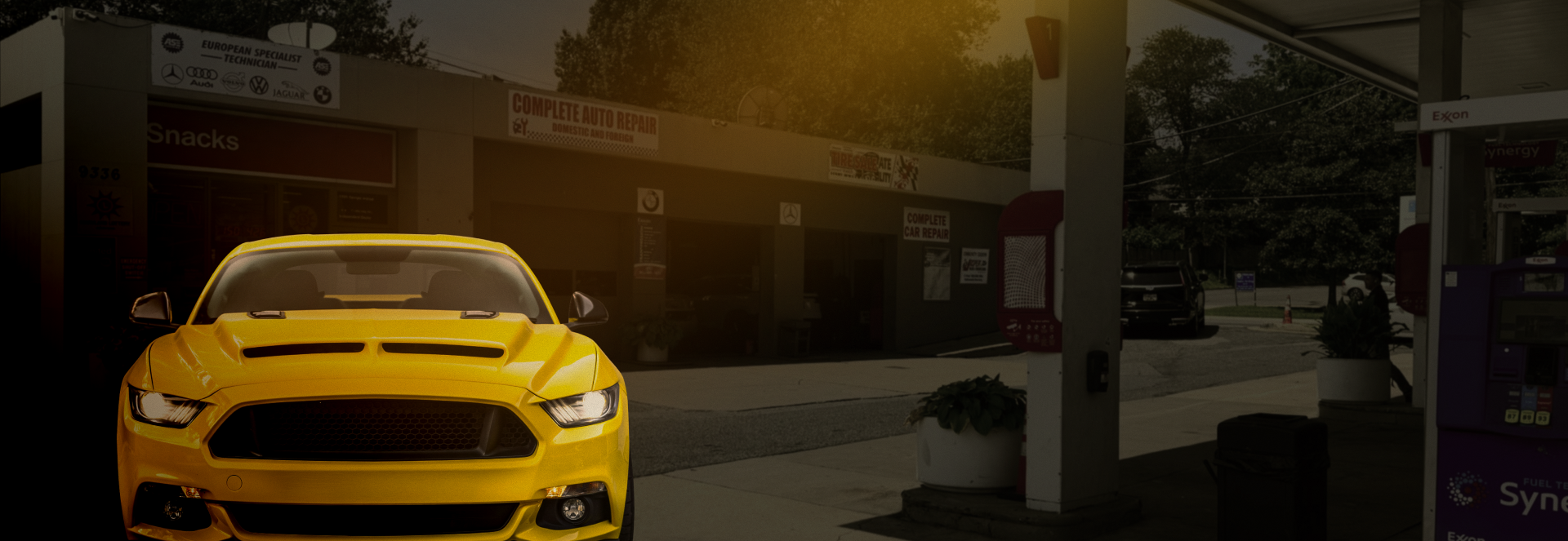 Yellow sports car at gas station.
