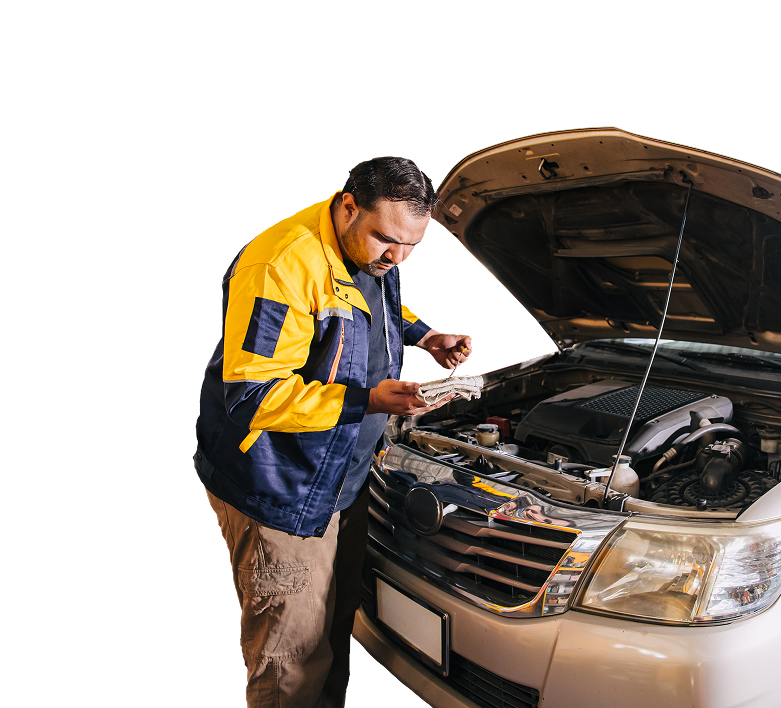 Mechanic in blue and yellow jacket inspecting car engine with hood open.