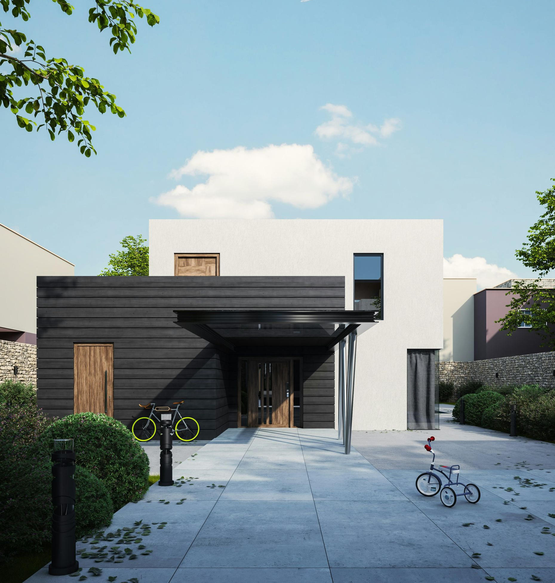 Modern house with dark wood siding, white walls, and a glass canopy over the entrance. Bikes sit in the yard.