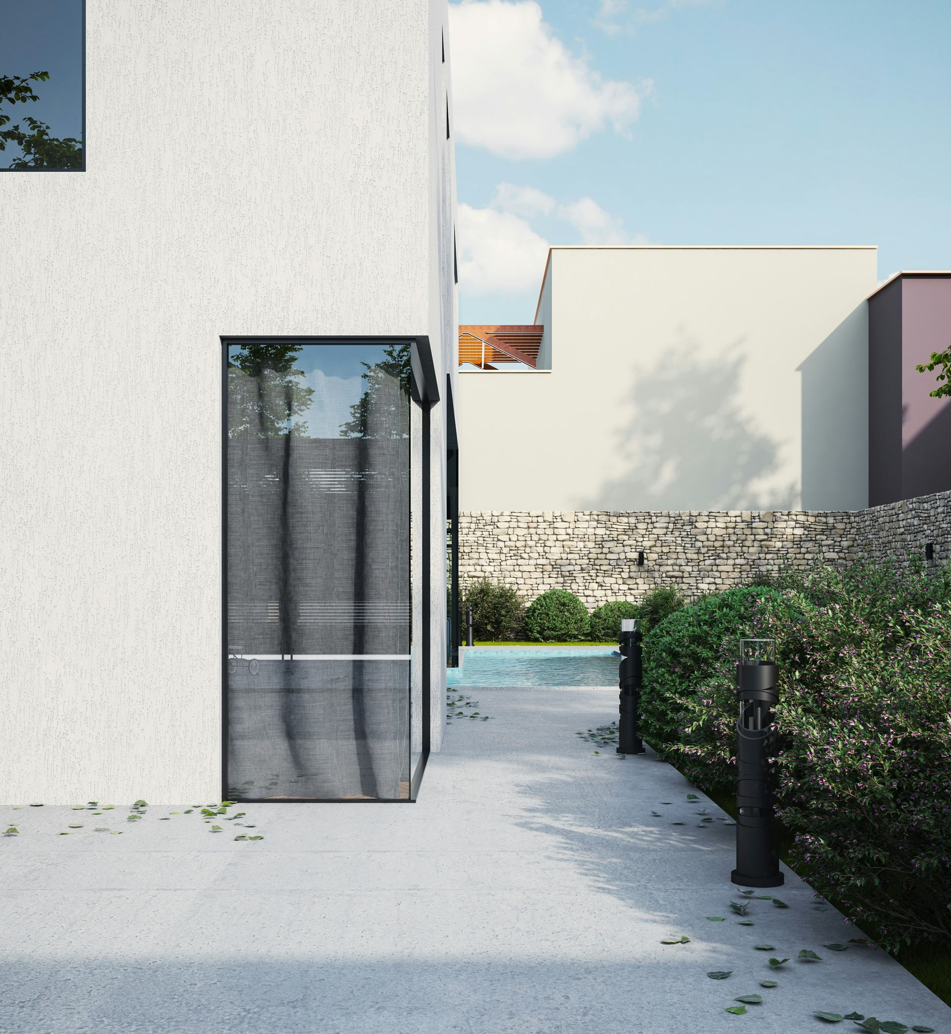 Modern white building with a glass door, concrete path, and greenery.