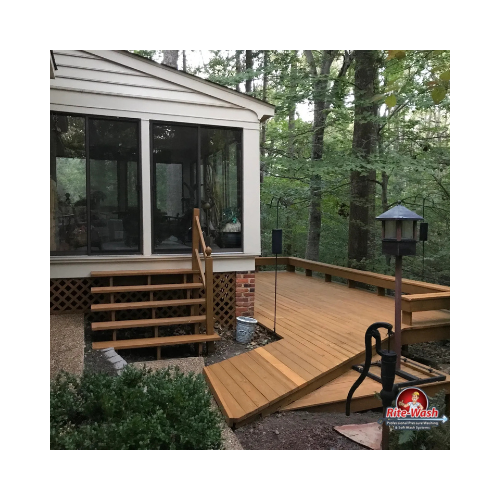 A large white house with a swimming pool in front of it at night.