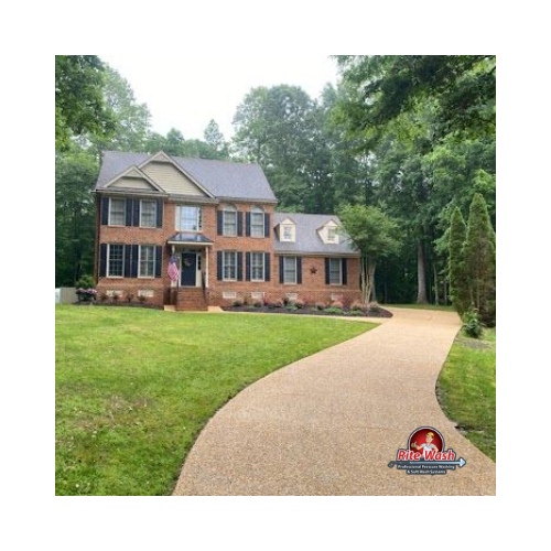 A gravel driveway leading to a house with a garage