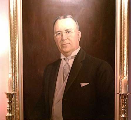 There is a tree in the middle of a field of flowers.