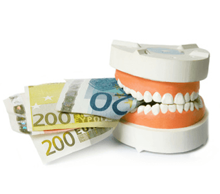 Ein Zahnmodell, das auf einem Bündel Euro-Banknoten beißt.