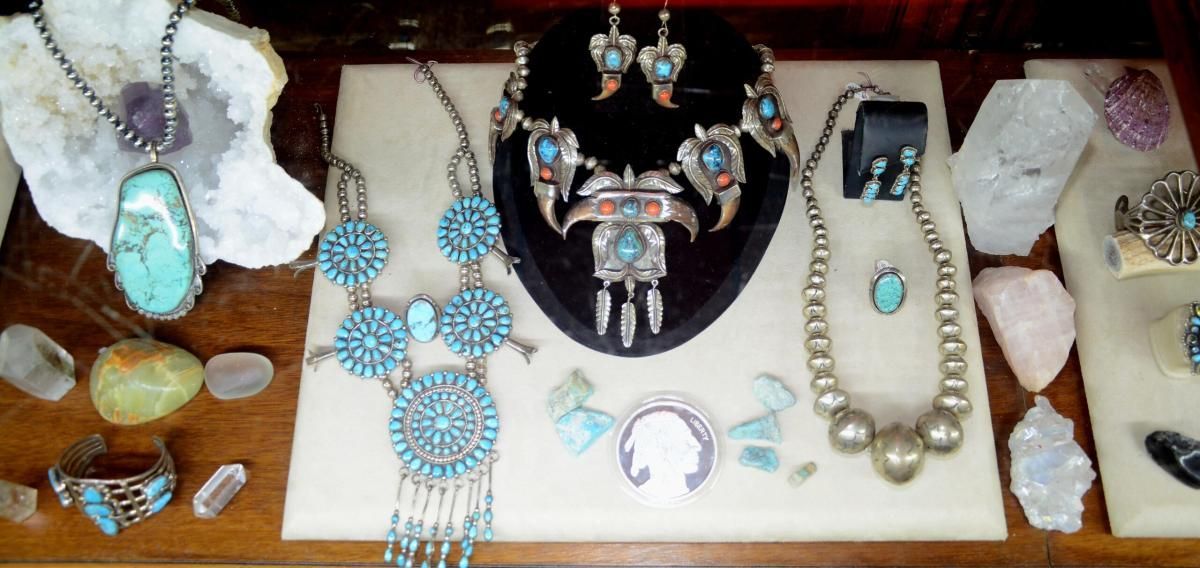 Jewelry display: necklaces, earrings, and bracelets with turquoise stones.