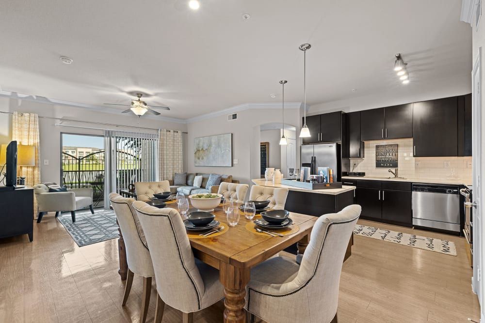 Spacious dining table and chairs oversee the kitchen at Marquis at the Reserve in Katy, TX.