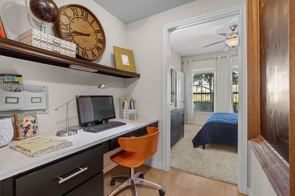 Home office space with a clock on the wall above the desk at Marquis at the Reserve in Katy, TX.