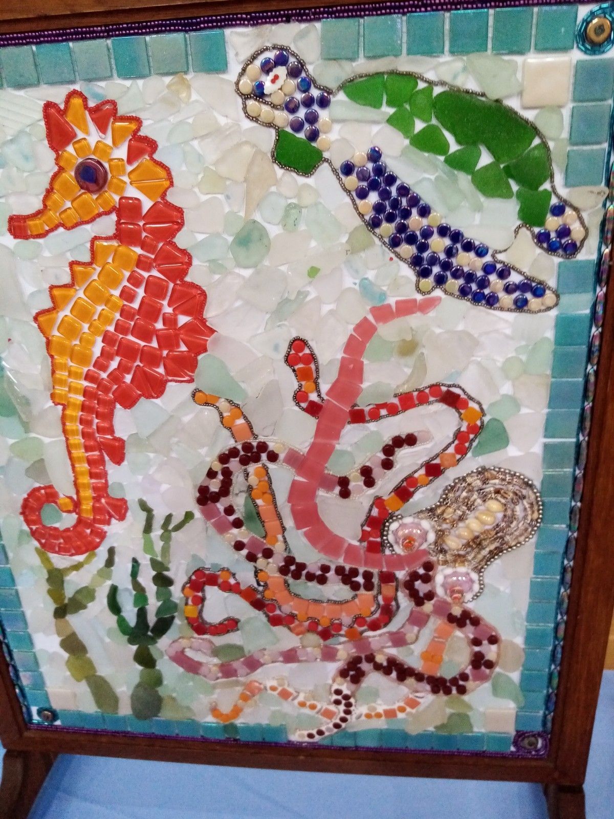 A mosaic of sea creatures including a seahorse octopus and turtle