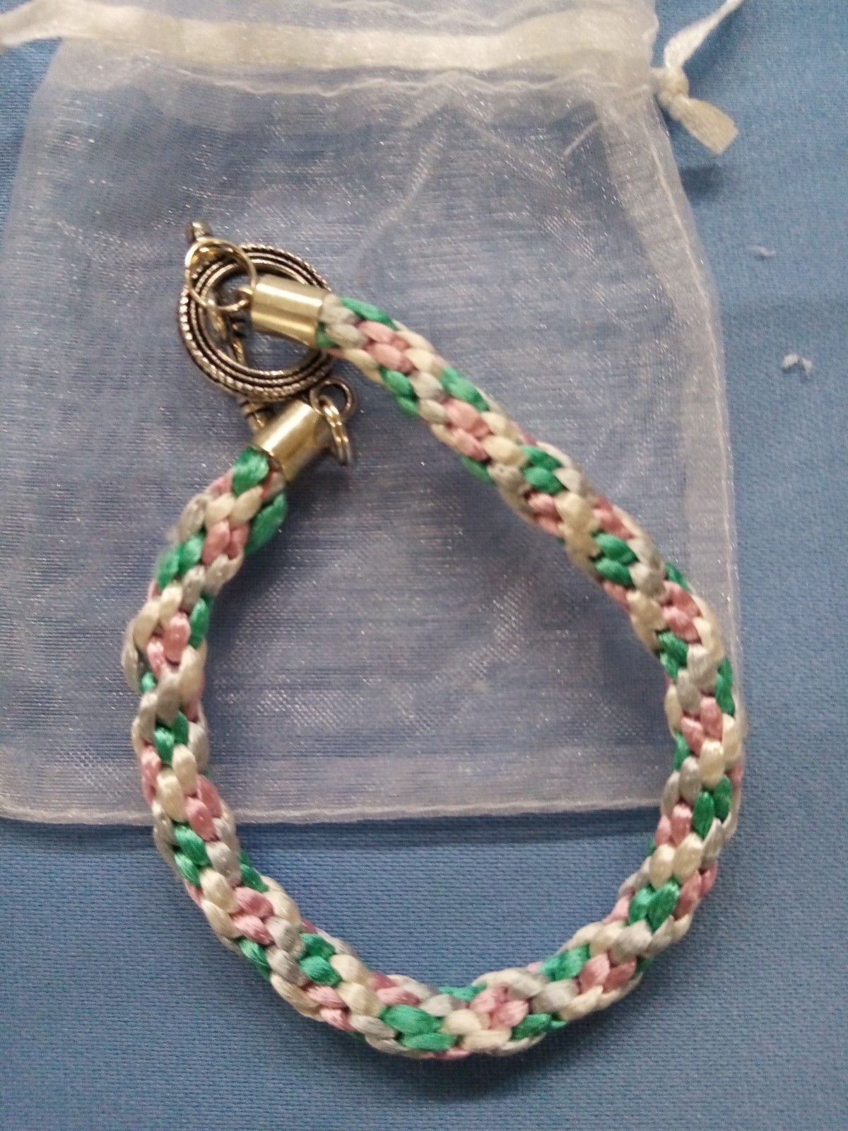 A braided bracelet is sitting in a clear bag