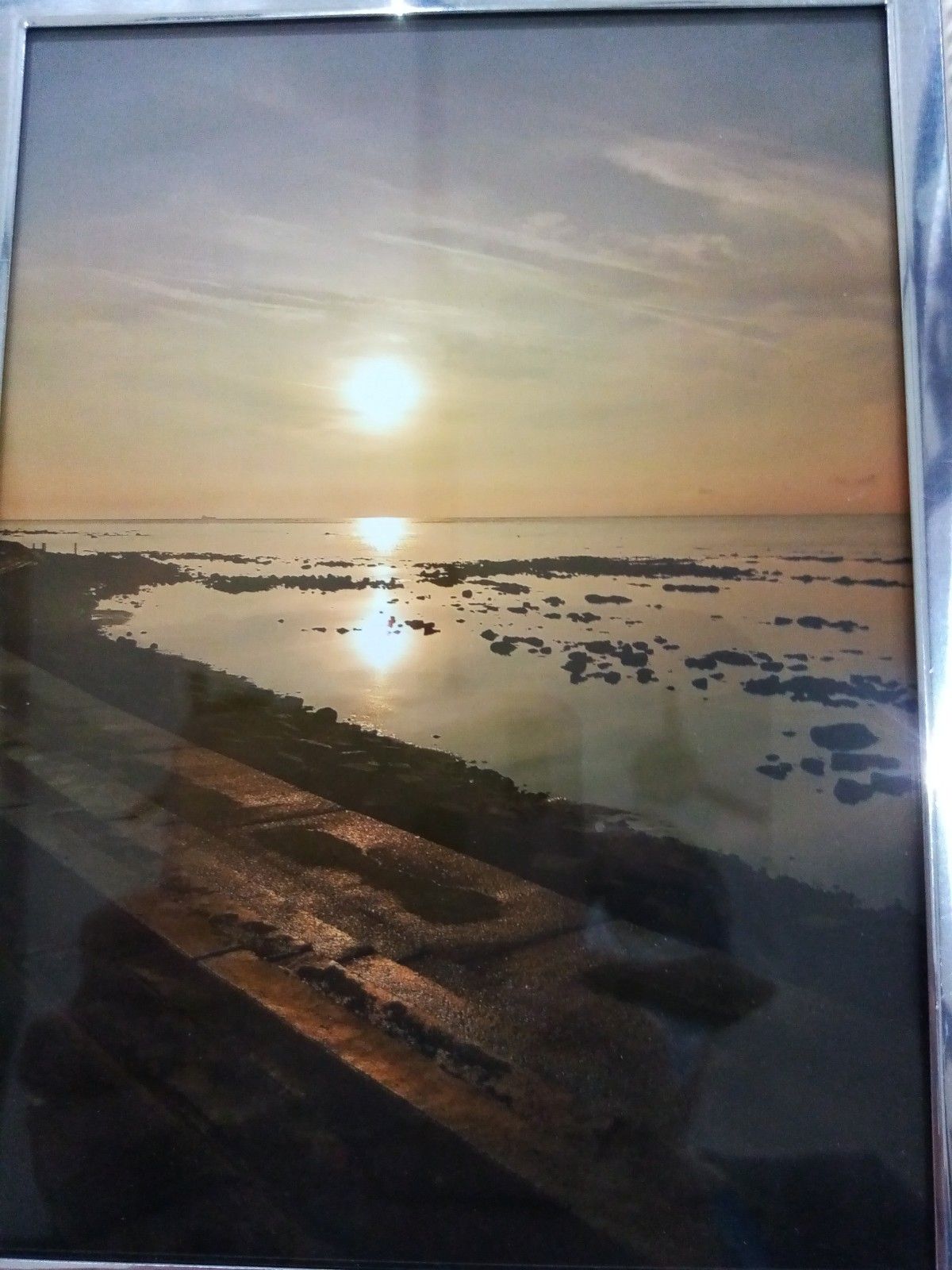 A picture of a sunset over a body of water