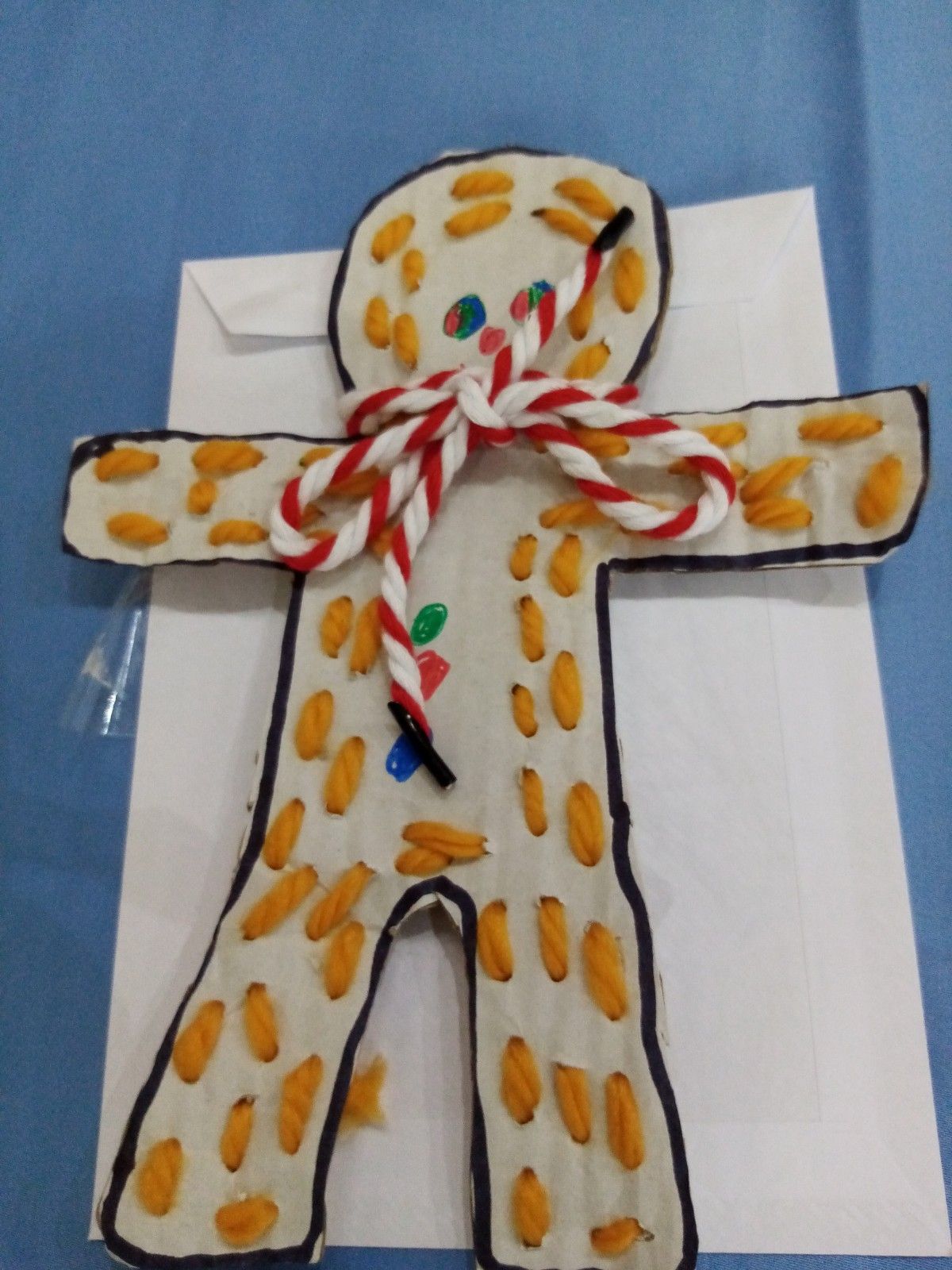A gingerbread man made out of nuts and candy canes