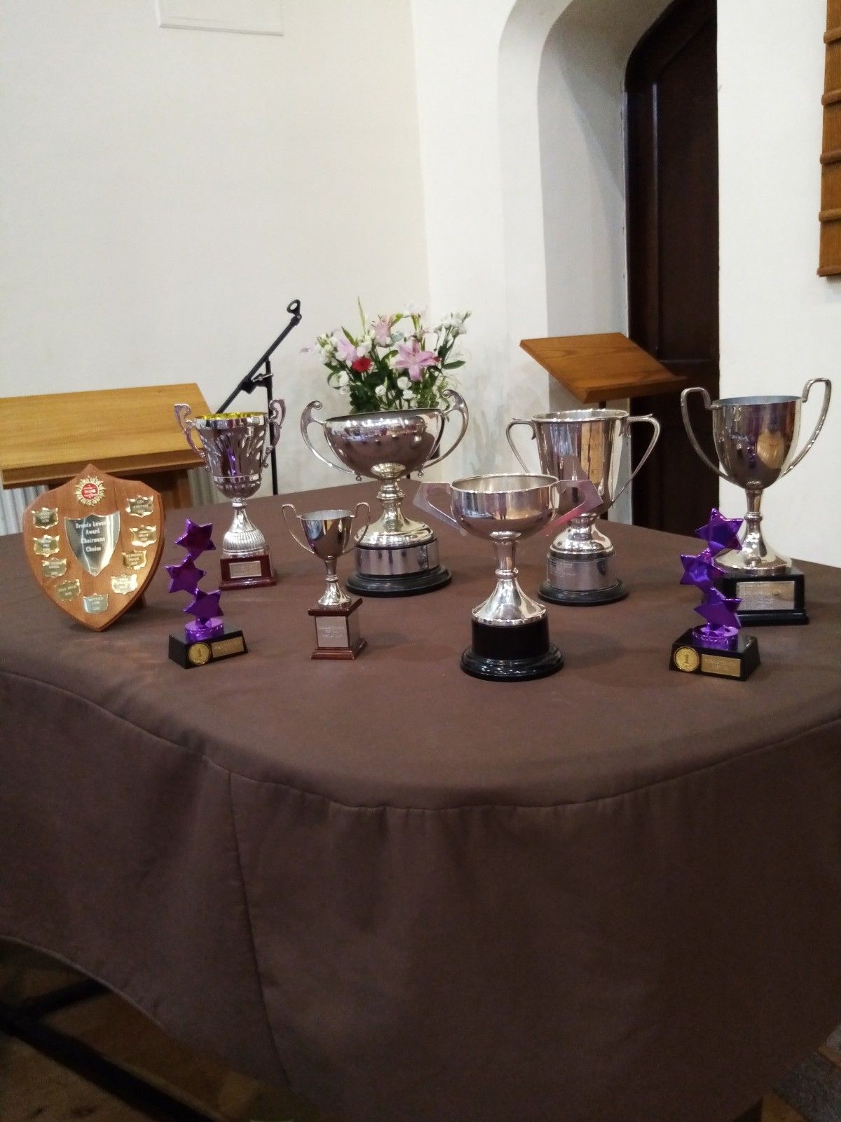 A table with trophies and a plaque that says ' a ' on it