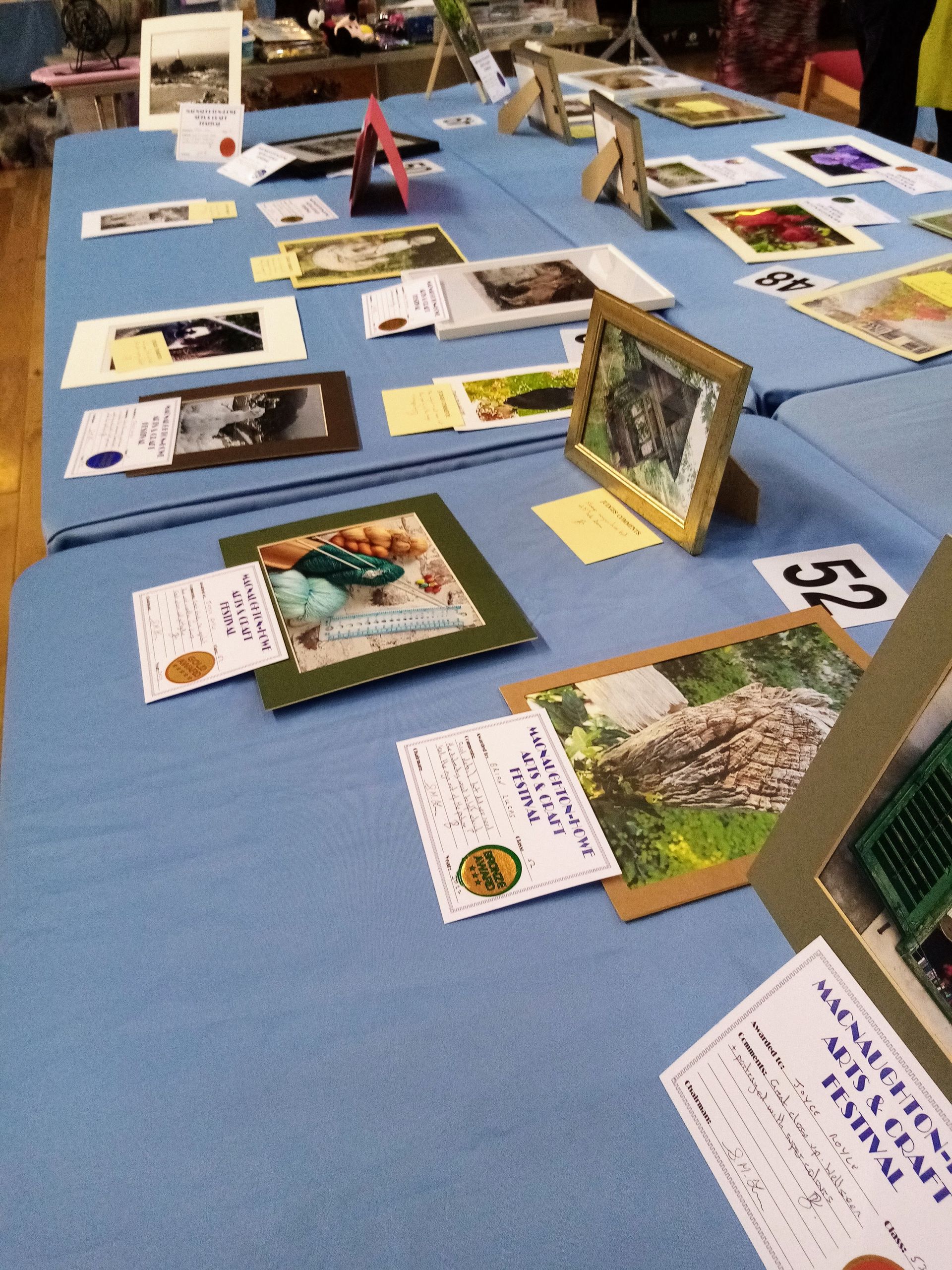 A table with a lot of pictures on it and one of them has the number 53 on it