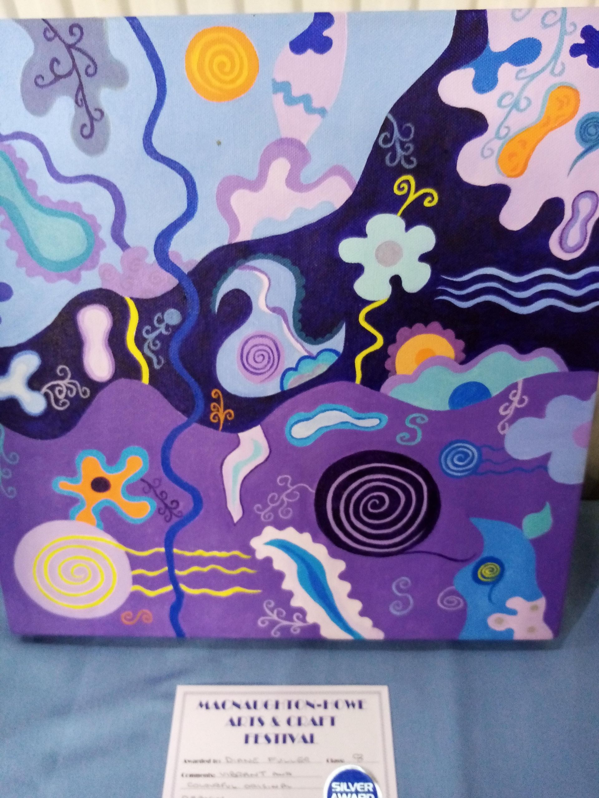 A painting on a canvas with a certificate of participation