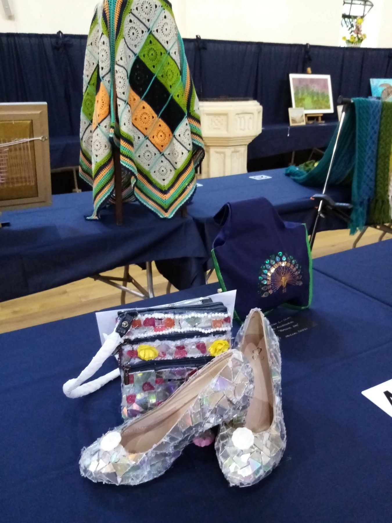 A pair of shoes and a purse are on a table