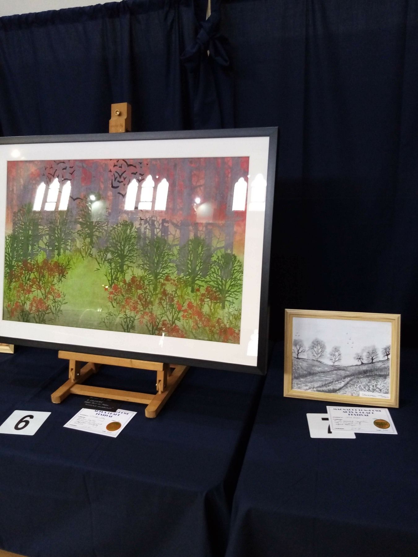 A painting on an easel is on display on a table