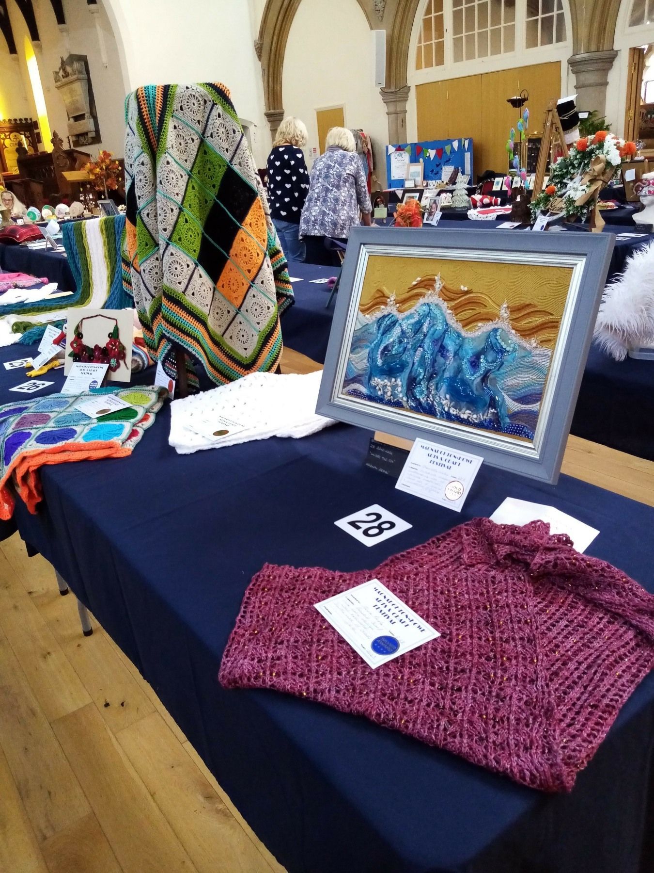 A table with a painting on it and a sweater on it.