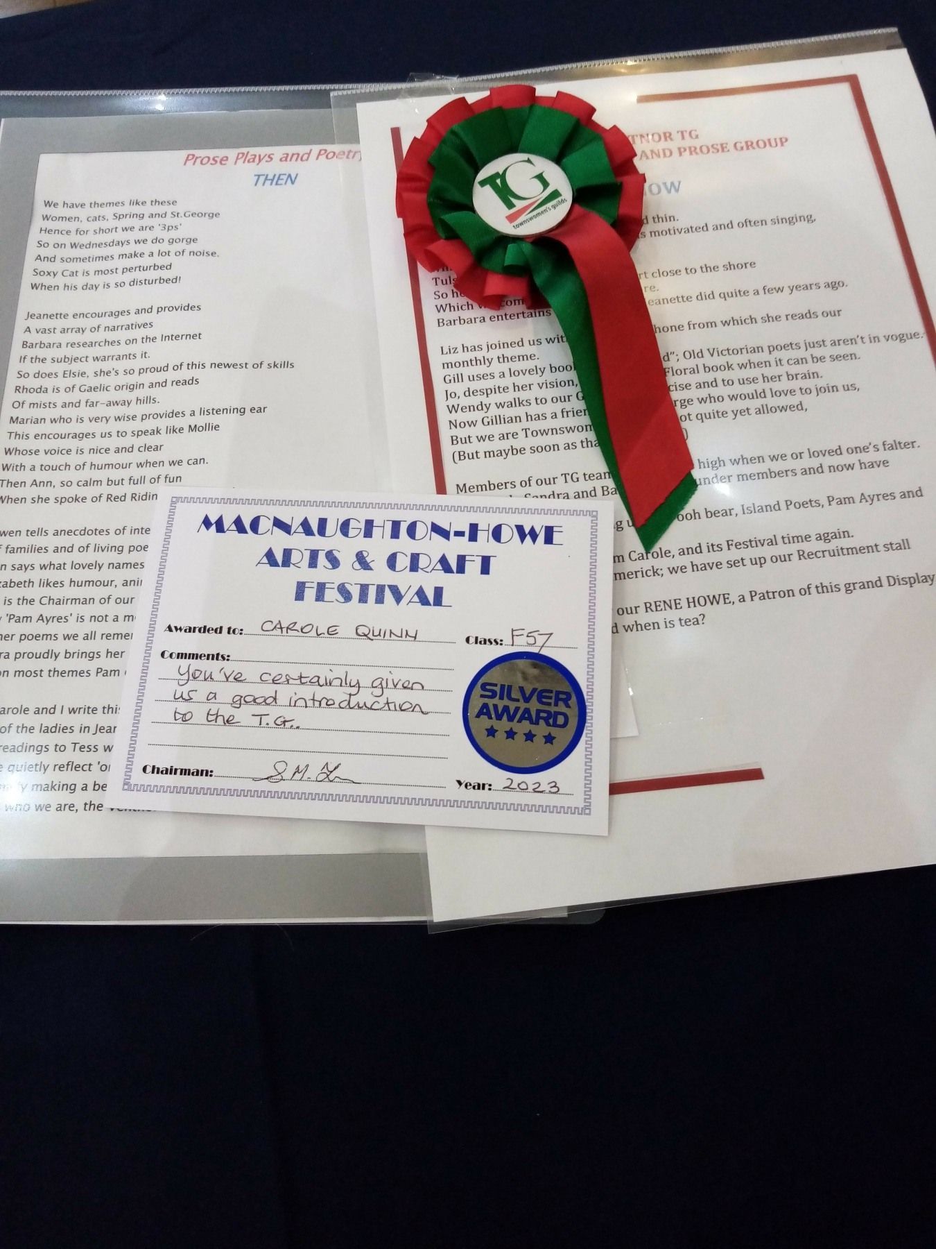 A red green and white ribbon sits on top of a certificate