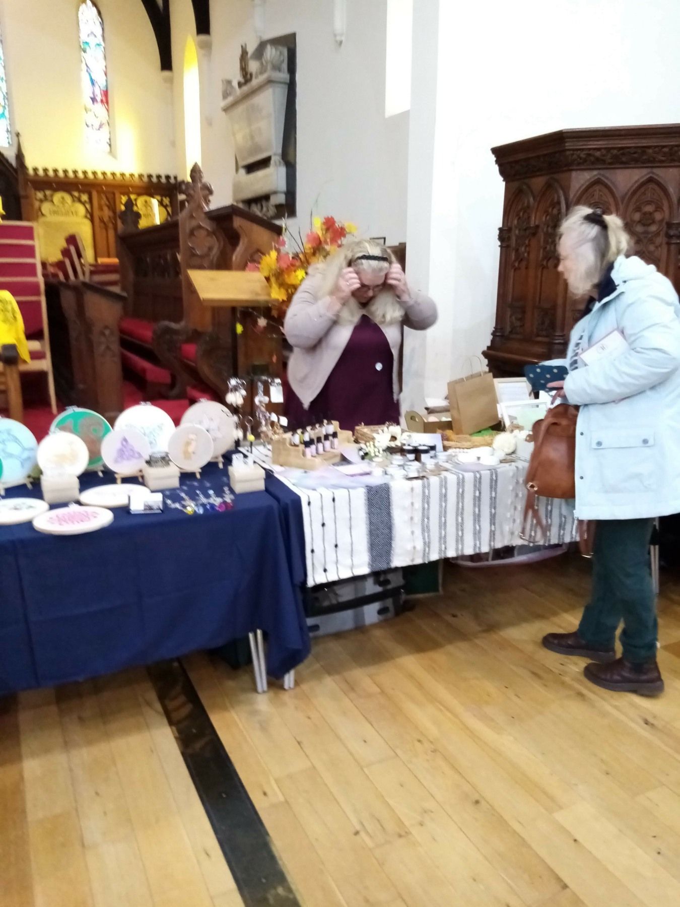 A woman standing in front of a table in a church