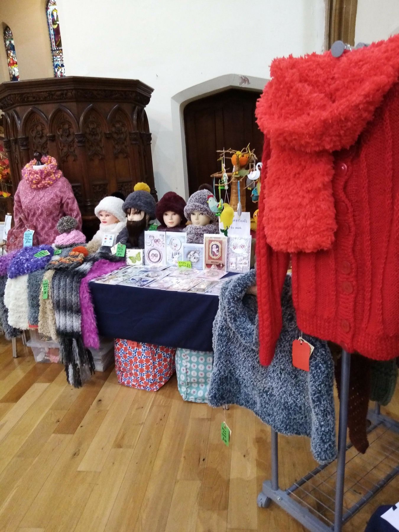 A table with a lot of knitted items on it