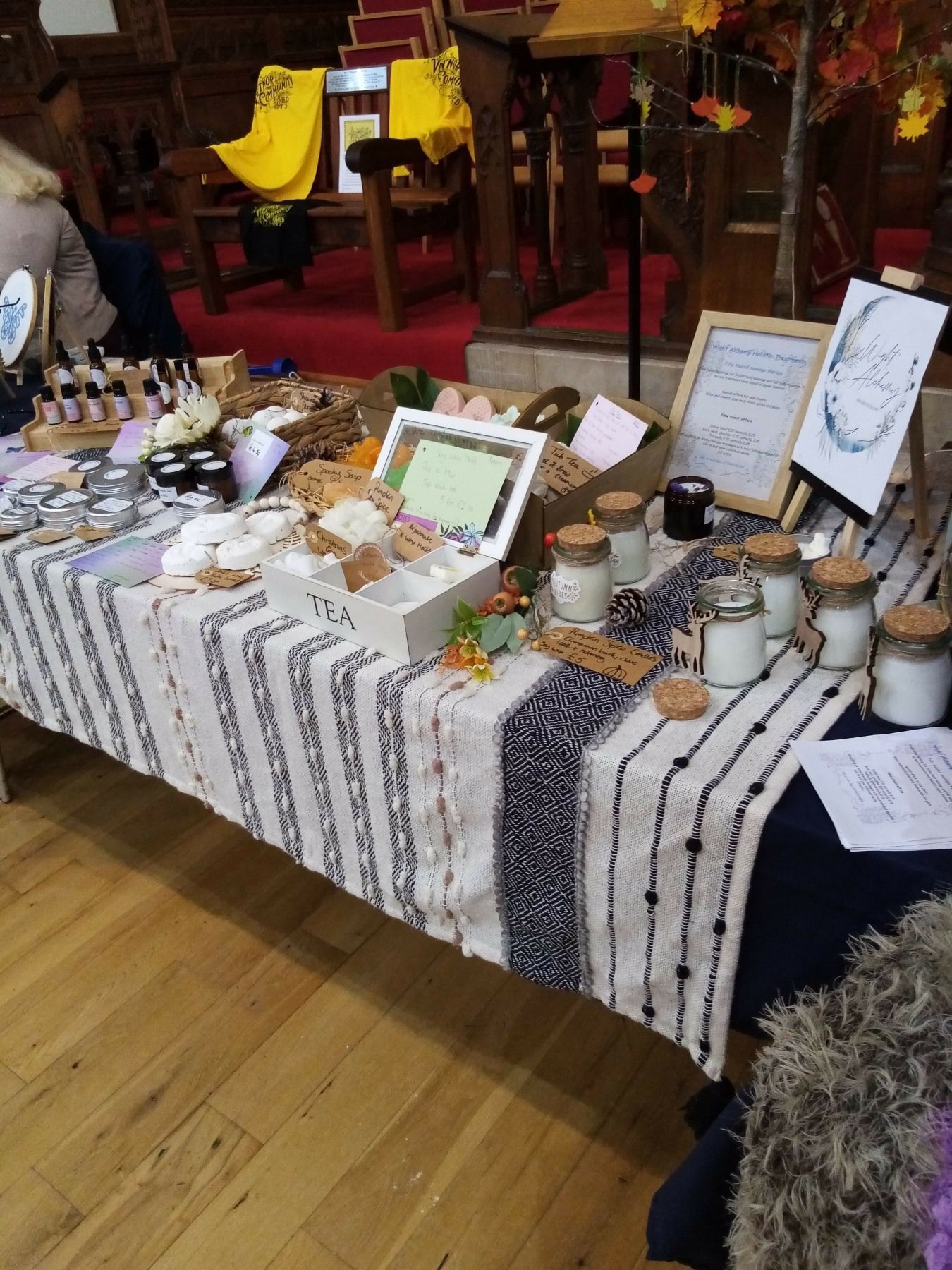 A table with a striped table cloth and candles on it
