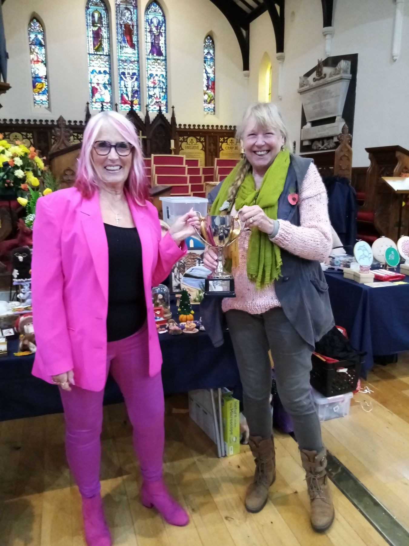 Two women standing next to each other in a church